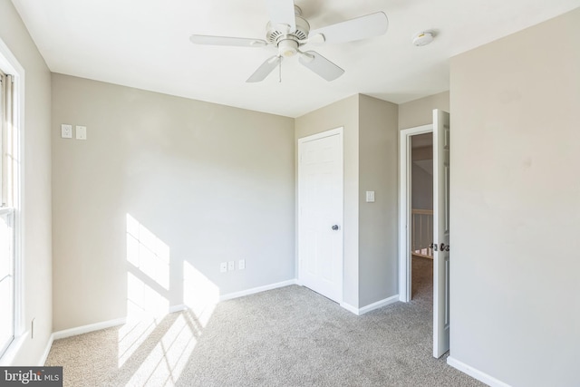 carpeted empty room with ceiling fan