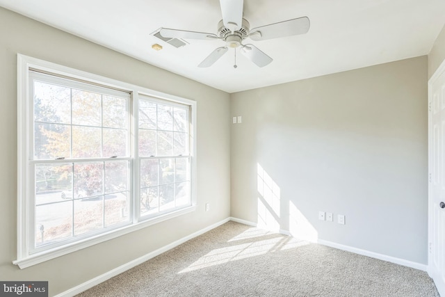 carpeted spare room with ceiling fan