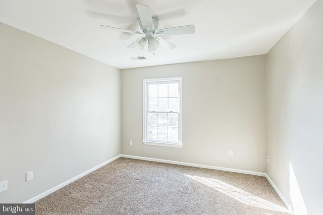 carpeted spare room featuring ceiling fan