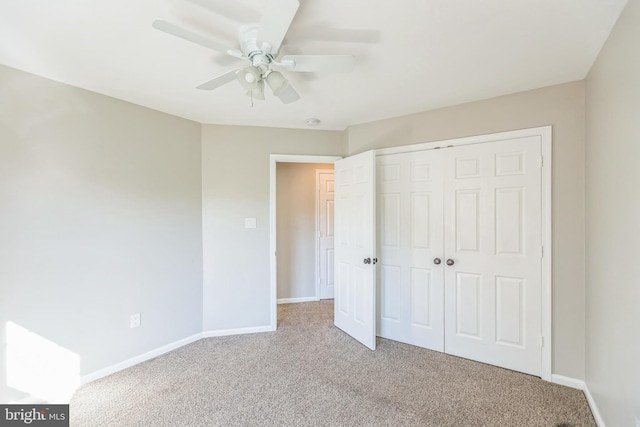 unfurnished bedroom with light colored carpet, ceiling fan, and a closet