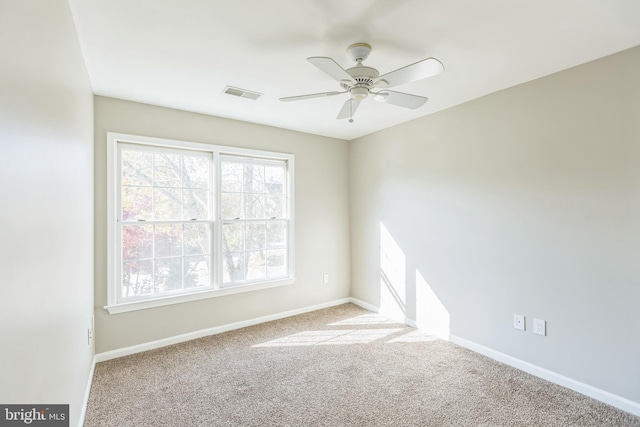 unfurnished room featuring ceiling fan and light colored carpet