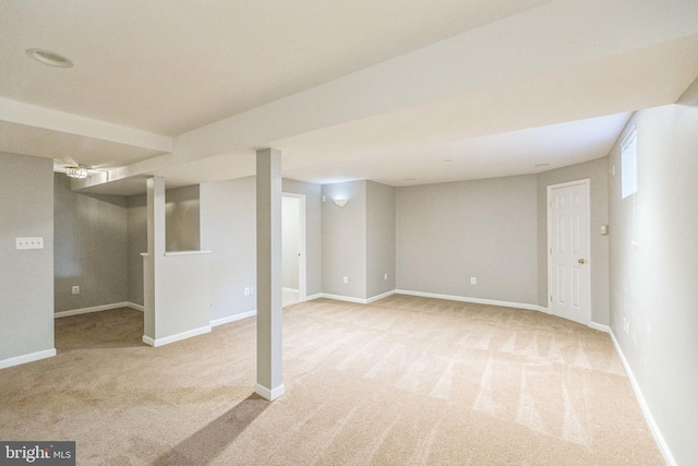 basement featuring light carpet