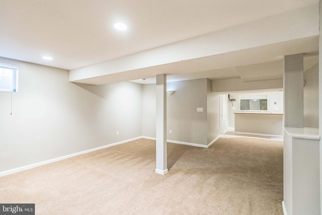 basement featuring light colored carpet