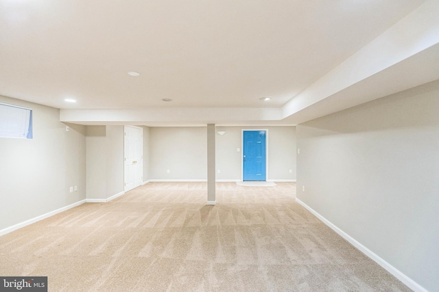 basement featuring light colored carpet