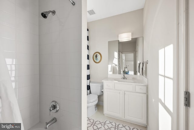 full bathroom featuring tile patterned flooring, toilet, vanity, and shower / bath combo