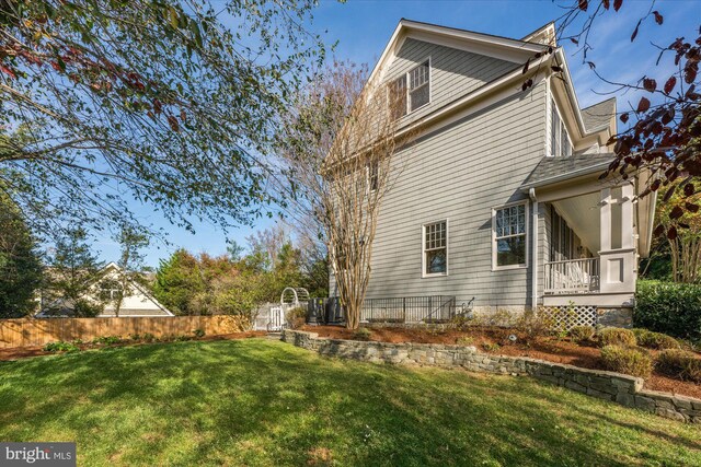 rear view of house featuring a lawn