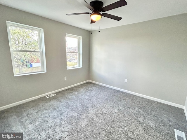 spare room featuring carpet and ceiling fan