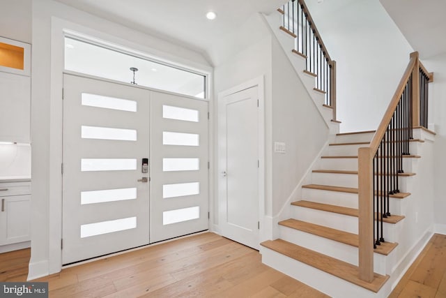 entryway with light hardwood / wood-style flooring and french doors