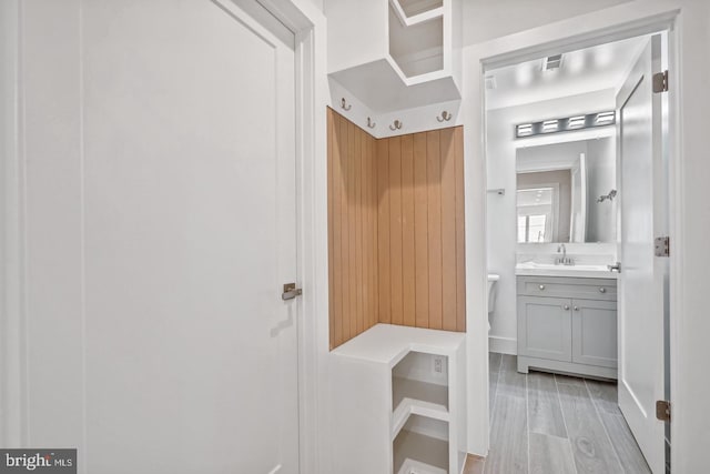 mudroom featuring sink and light hardwood / wood-style floors