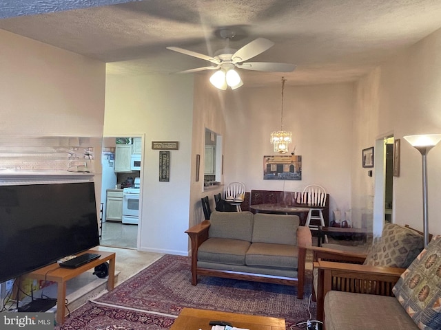 carpeted living room featuring a towering ceiling, ceiling fan with notable chandelier, and a textured ceiling