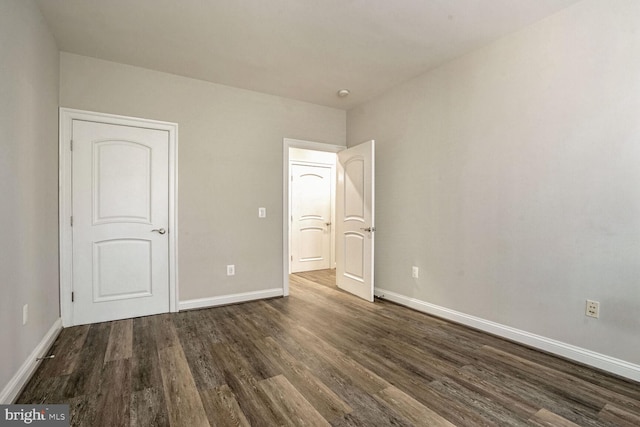 unfurnished bedroom with dark wood-type flooring