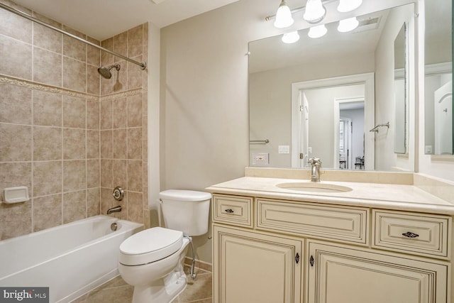 full bathroom featuring tile patterned flooring, vanity, tiled shower / bath combo, and toilet