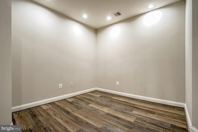 unfurnished room with dark hardwood / wood-style floors