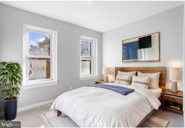 bedroom with light colored carpet