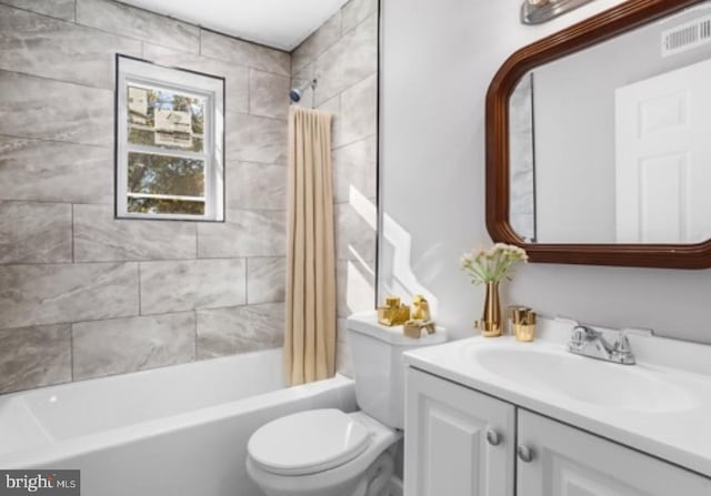 full bathroom featuring vanity, toilet, and shower / tub combo with curtain