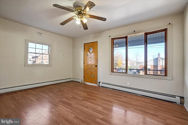 unfurnished room with baseboard heating, hardwood / wood-style flooring, and ceiling fan