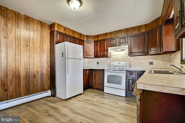 kitchen with light wood-type flooring, backsplash, sink, a baseboard heating unit, and white appliances