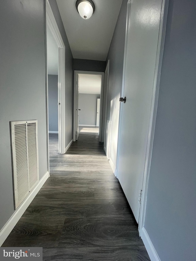 hallway with dark hardwood / wood-style floors