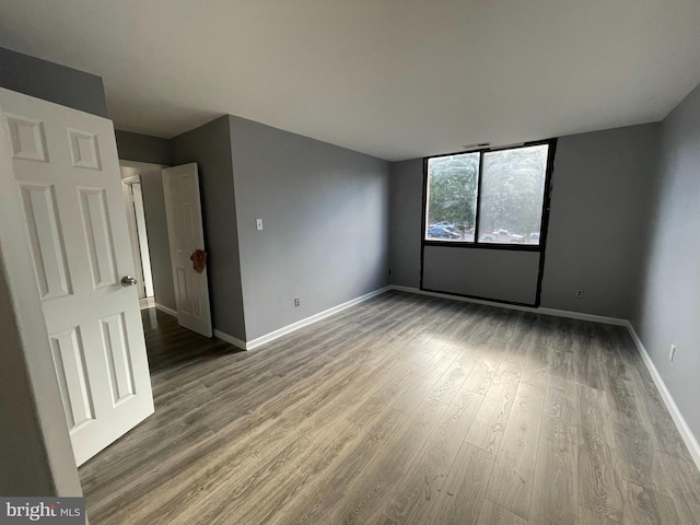 empty room with hardwood / wood-style flooring