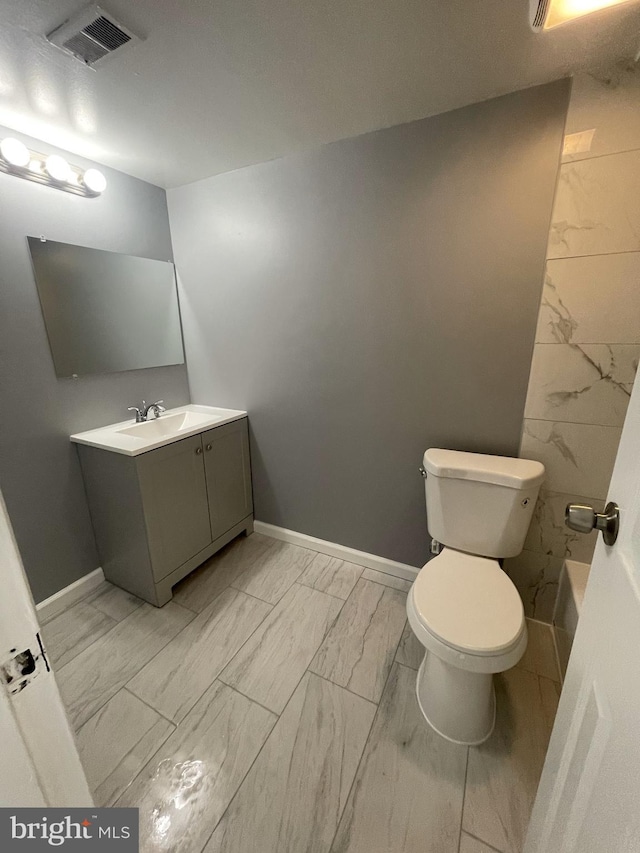 bathroom featuring vanity and toilet