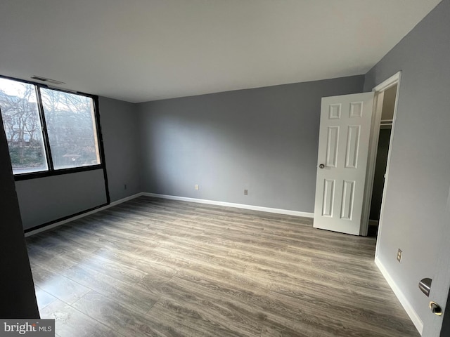 spare room with wood-type flooring