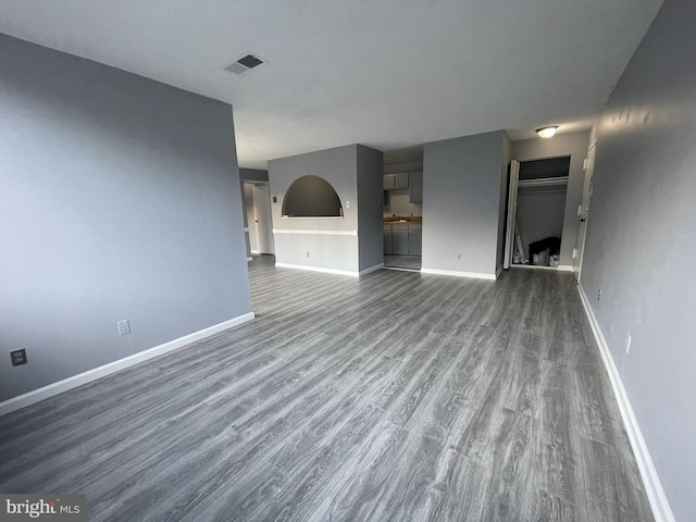 unfurnished living room featuring dark wood-type flooring