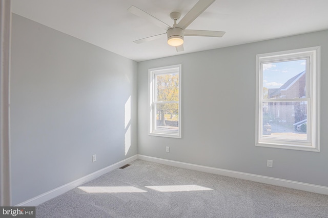 spare room featuring ceiling fan and light carpet