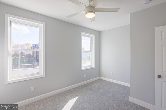 spare room with carpet and ceiling fan