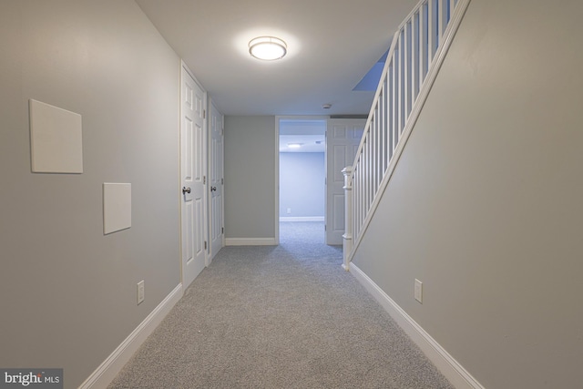 corridor featuring light colored carpet