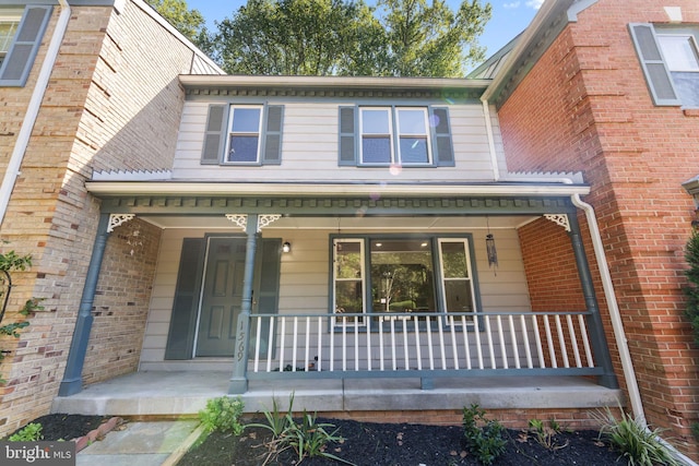 view of exterior entry with a porch