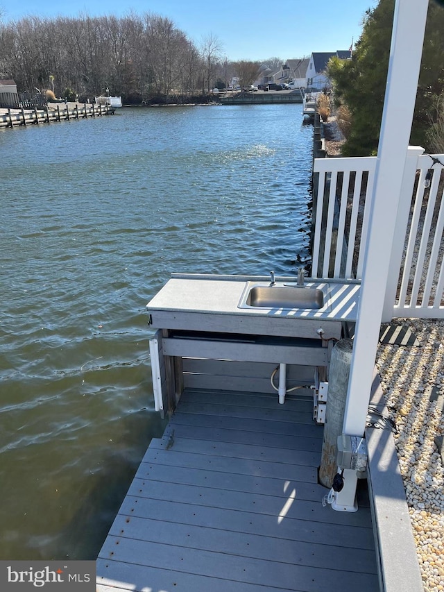 view of dock featuring sink and a water view