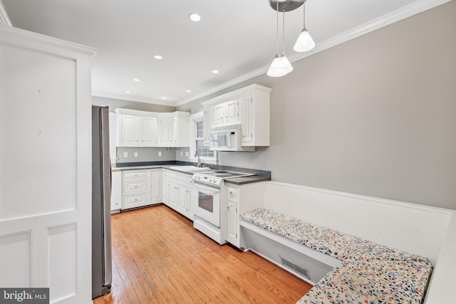 kitchen with crown molding, light hardwood / wood-style floors, decorative light fixtures, white appliances, and white cabinets