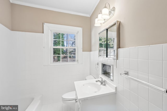 bathroom featuring vanity, crown molding, toilet, a tub to relax in, and tile walls