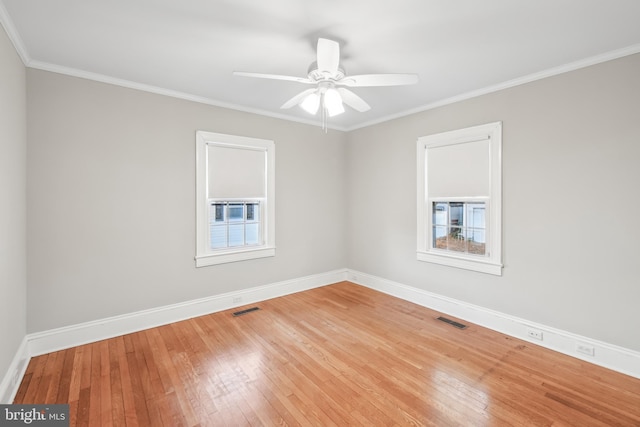 spare room with hardwood / wood-style floors, ceiling fan, and crown molding