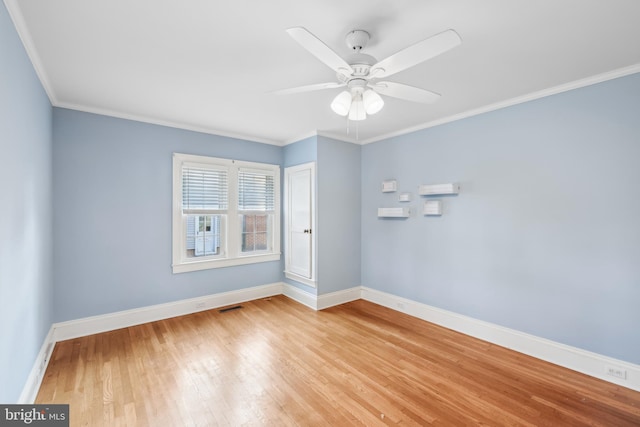 spare room featuring light hardwood / wood-style floors, ceiling fan, and crown molding