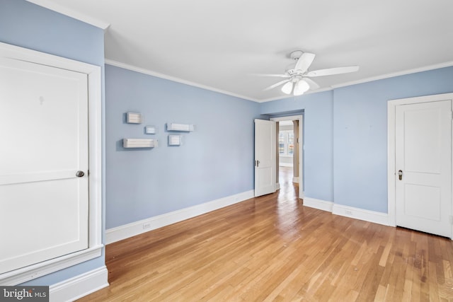 spare room with crown molding, ceiling fan, and light hardwood / wood-style floors