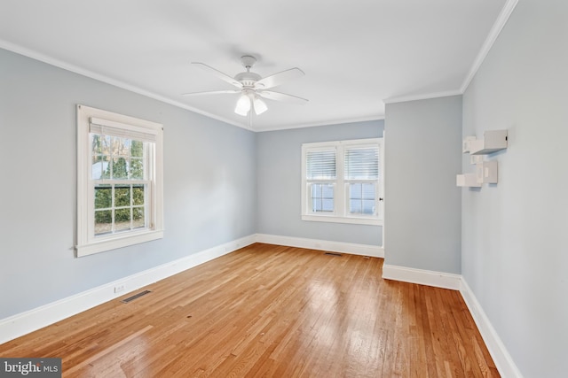 empty room with ceiling fan, light hardwood / wood-style floors, and ornamental molding