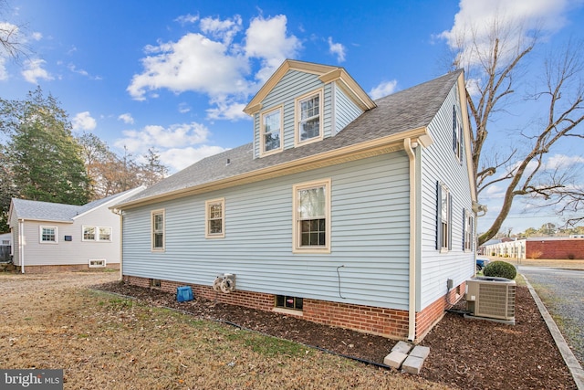 rear view of house featuring central AC unit