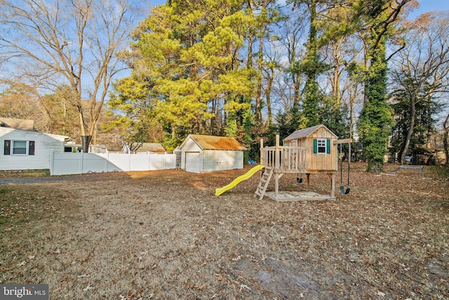 view of yard with a playground, an outbuilding, and a garage