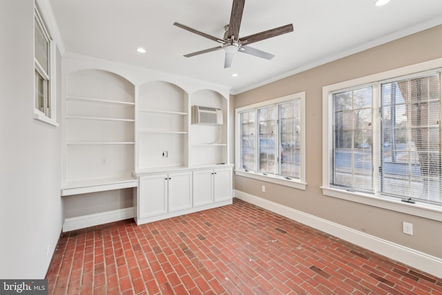 spare room featuring ceiling fan, a healthy amount of sunlight, ornamental molding, and a wall mounted AC