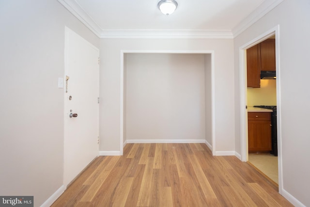 hallway featuring light hardwood / wood-style flooring and crown molding