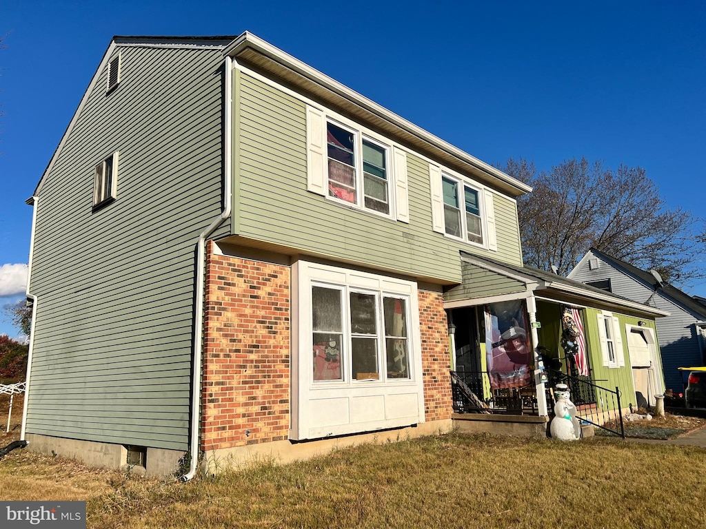 rear view of property with a yard