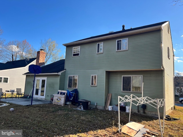 rear view of property featuring a patio area and french doors