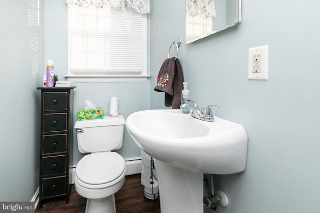 bathroom with hardwood / wood-style floors, a baseboard radiator, and toilet