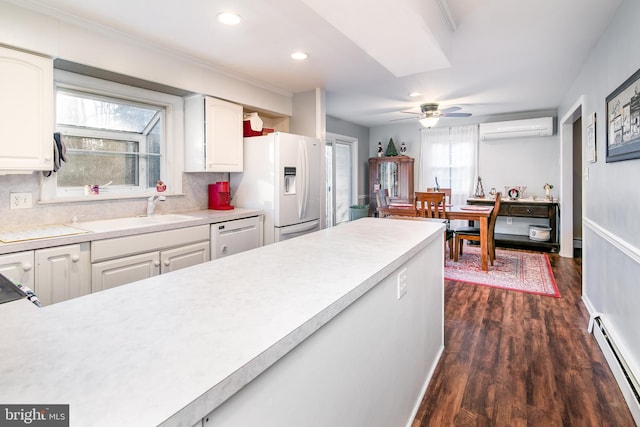 kitchen featuring a baseboard radiator, tasteful backsplash, dark hardwood / wood-style floors, an AC wall unit, and white appliances