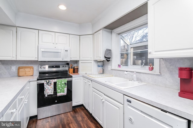 kitchen featuring dark hardwood / wood-style flooring, white appliances, white cabinetry, and sink