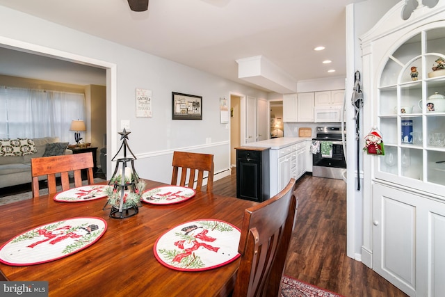 dining area featuring dark hardwood / wood-style floors and ceiling fan