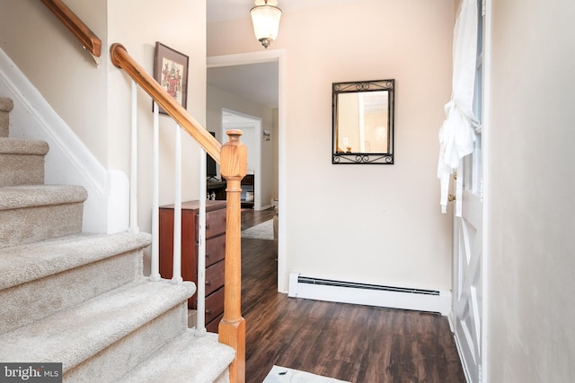 staircase with hardwood / wood-style flooring and baseboard heating