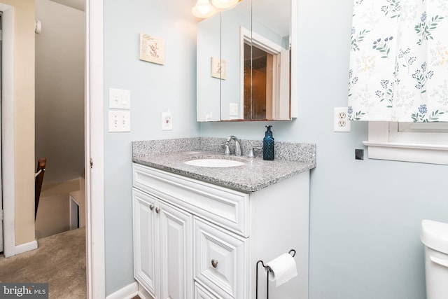 bathroom featuring vanity and toilet