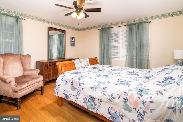 bedroom with hardwood / wood-style flooring and ceiling fan